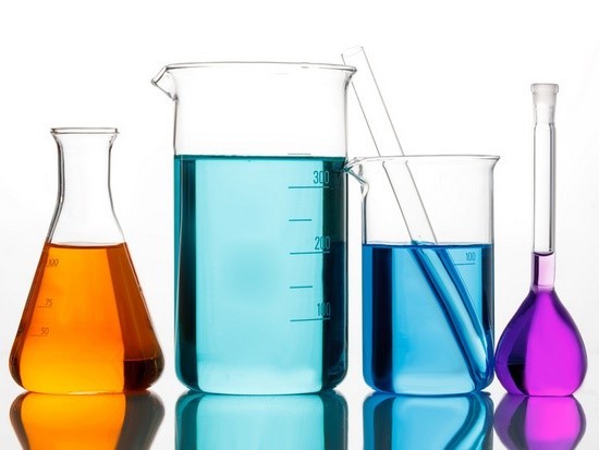 photo of various colored liquids in beakers